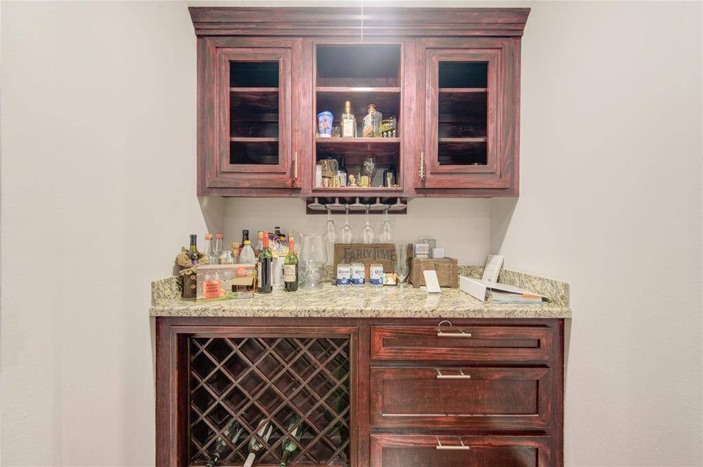 This elegant built-in bar area, crafted from rich dark wood, is the perfect blend of style and functionality.
