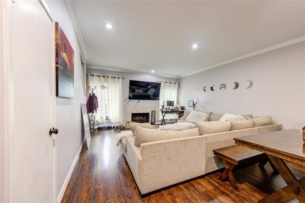 Step into this inviting living room where polished hardwood floors and recessed lighting enhance a neutral color scheme.