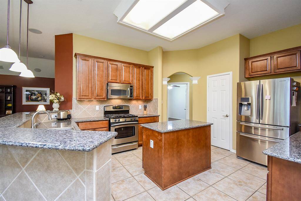 This view of the kitchen shows the large amount of cabinets and countertops in the Kitchen.