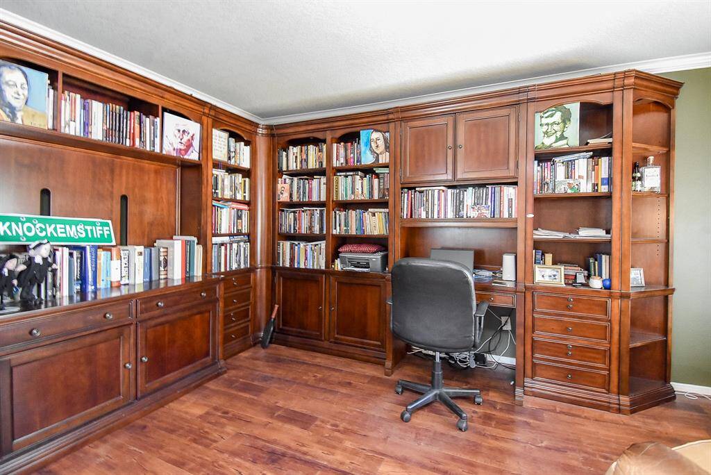 The study is spacious and has plenty of light coming in from the large window.