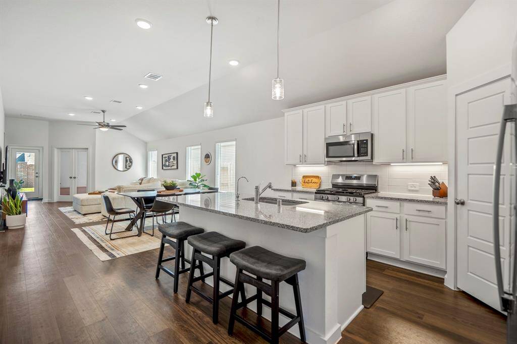 Open concept kitchen, dining and living spaces
