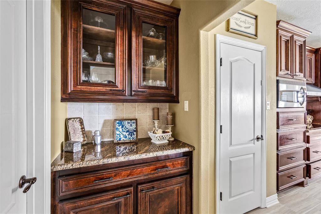 Walk-in pantry with extended dry bar area and more cabinets.