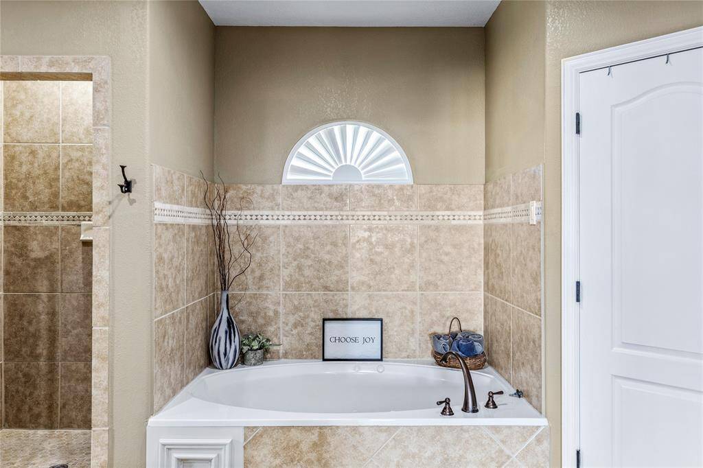 Jetted tub and separate shower in primary bathroom.