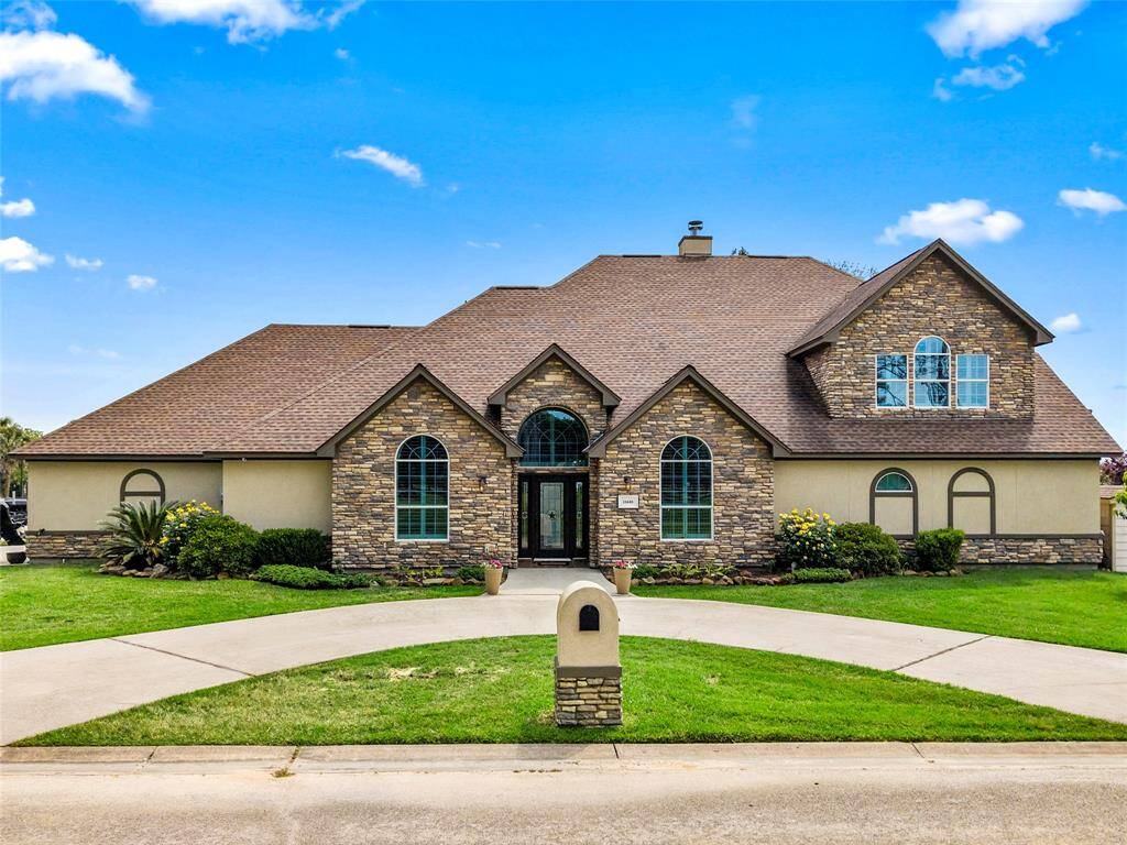 Stucco and Stone elevation with circle driveway.