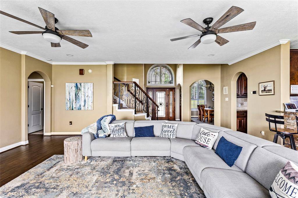 Open concept living room with access to kitchen, dining room and primary bedroom.