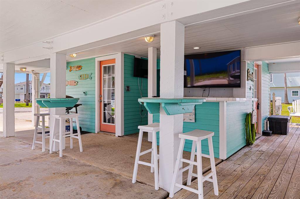 To the left shows one of two access doors to ground level guest suite (separate entrance located at front of home) - door to the right contains water heater and additional storage space