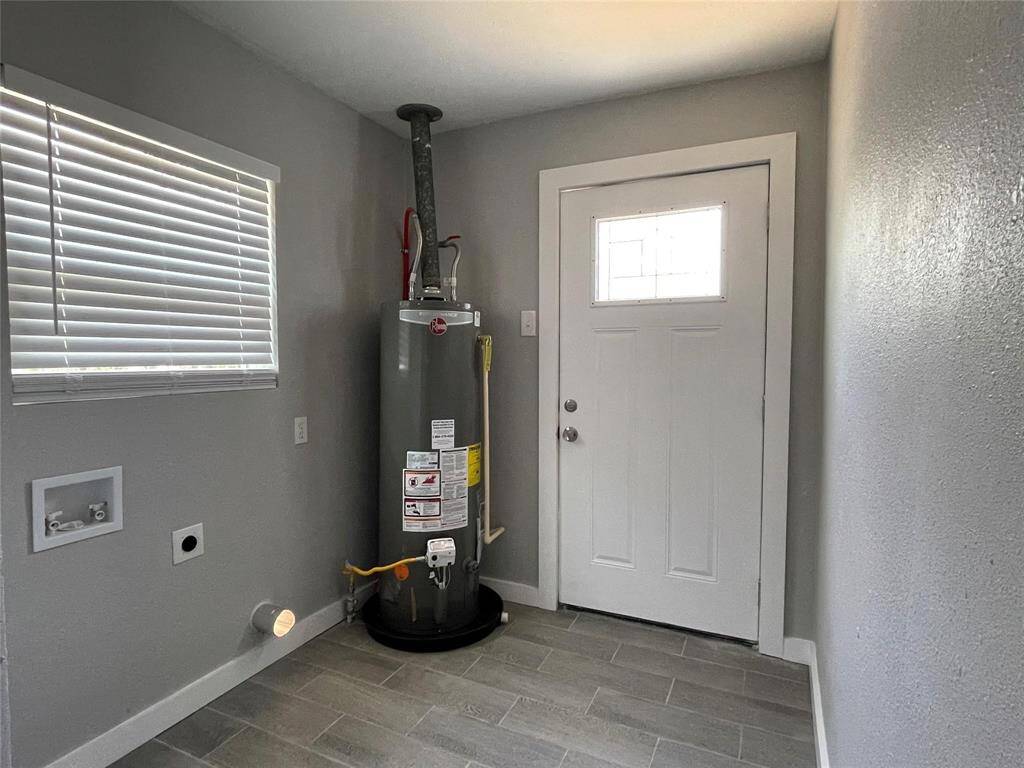 This utility/laundry room is spacious and ready for a washer/dryer.
