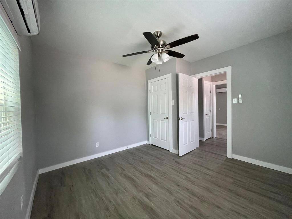This bedroom continues the sleek modern aesthetic, an expansive window with natural light and split unit A/C for personalized comfort.