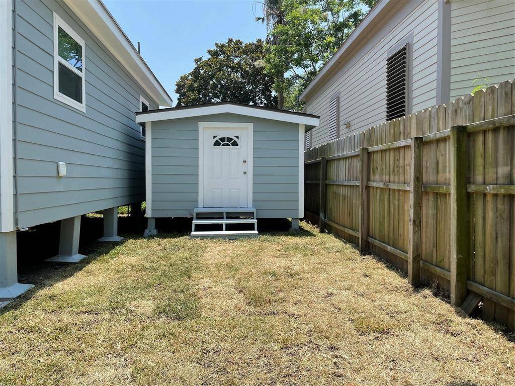 An adorable matching storage shed on the side of this home adds to the stylish charm and convenience for storage.