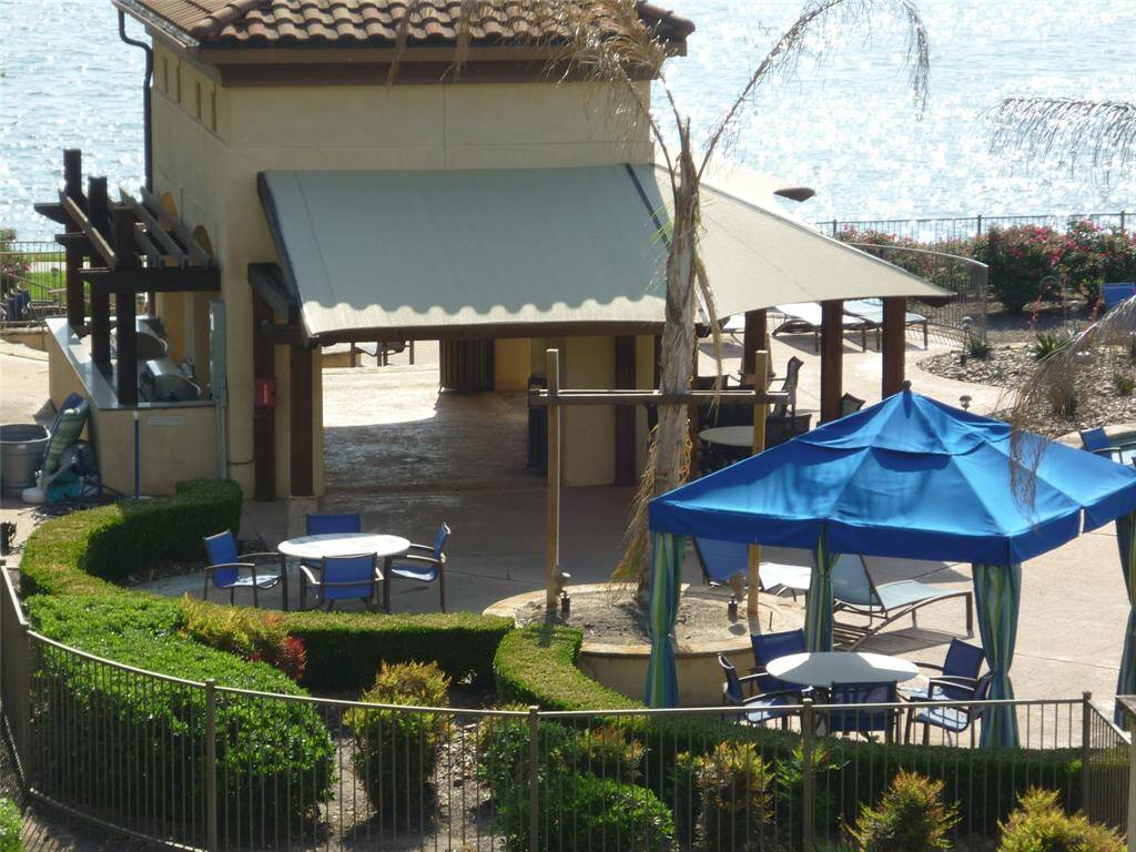 Gas grills and firepit are part of the pool area. Infinity pool and waterfall side. Day dock also.  Boat docks at edge of property of 1097