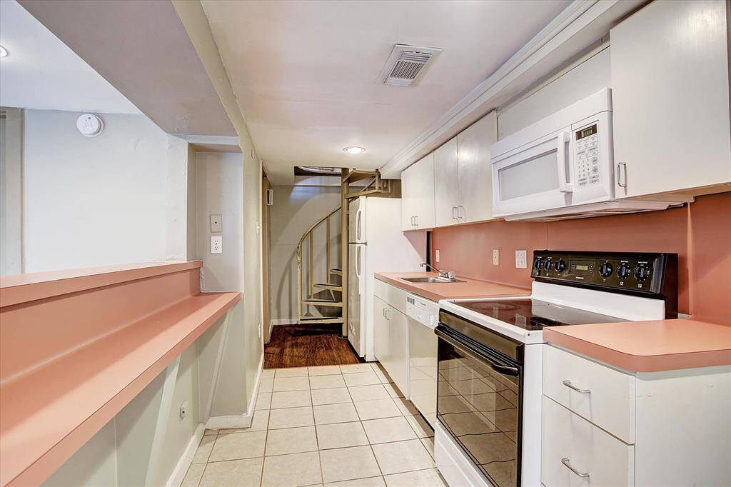 Carriage house kitchen. Spiral staircase leads to bedroom and bath on 2nd floor.