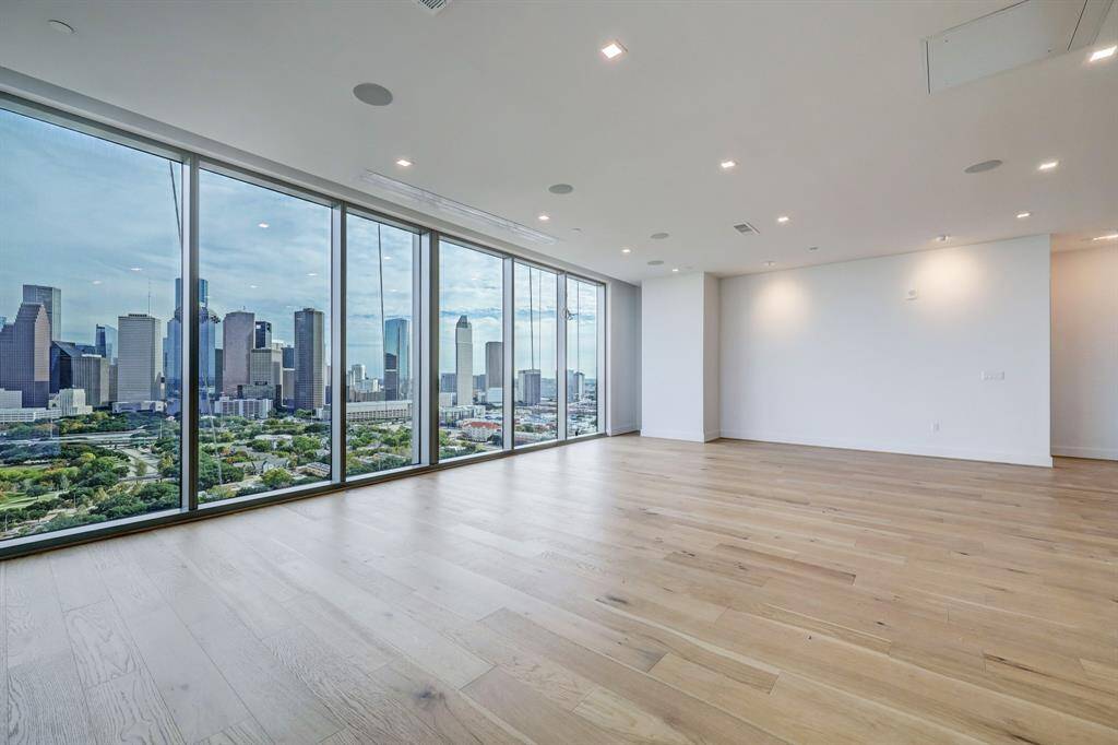 Downtown and Bayou views. Spacious living area includes souround sound, engineetred hard wood flooring and media projector and screen.