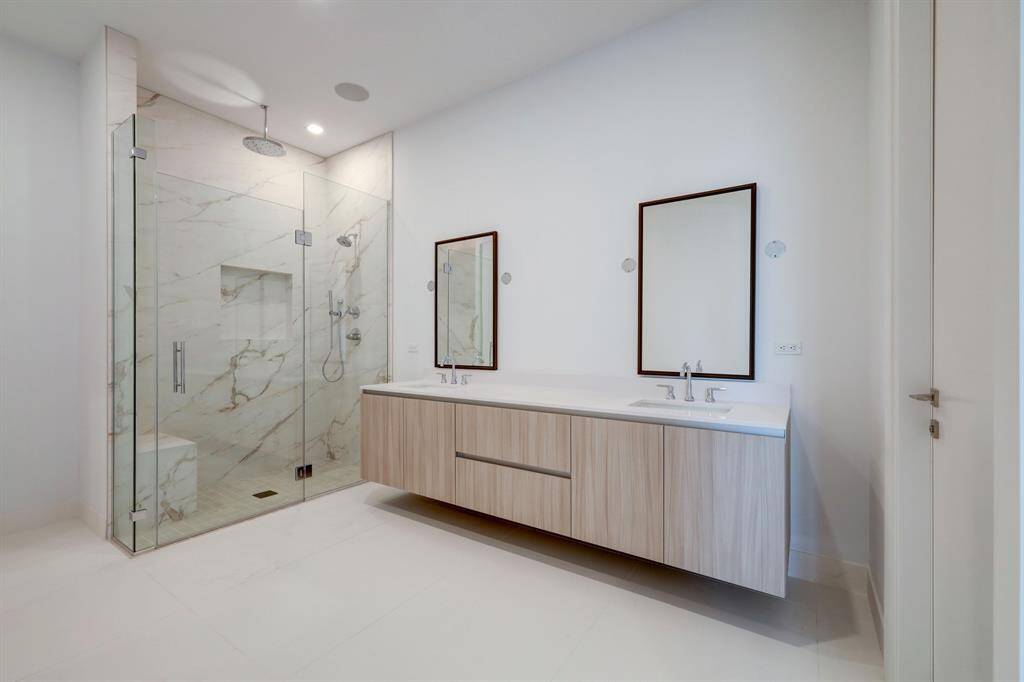 Primary bathroom features a large walk in shower, double vanity and large walk in closet.