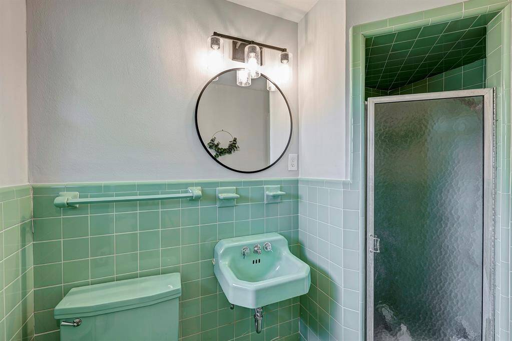 Vintage-style primary bathroom with walk-in shower.