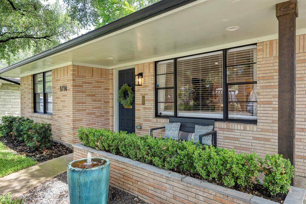 Charming front porch overlooks the yard. Sprinkler system in place.
