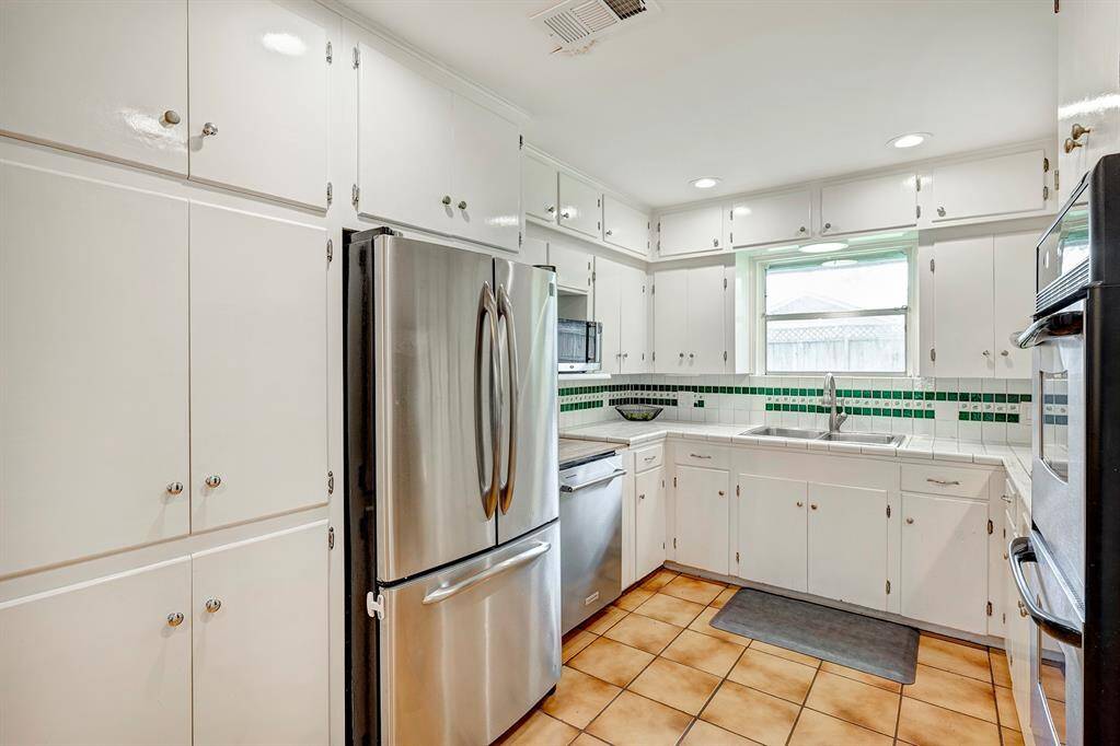 Efficient kitchen offers stainless steel appliances including refrigerator, microwave, dishwasher and double wall ovens. Pantry as well.