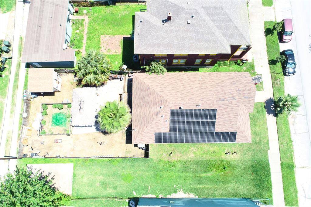 The backyard also includes a storage building and garden areas!