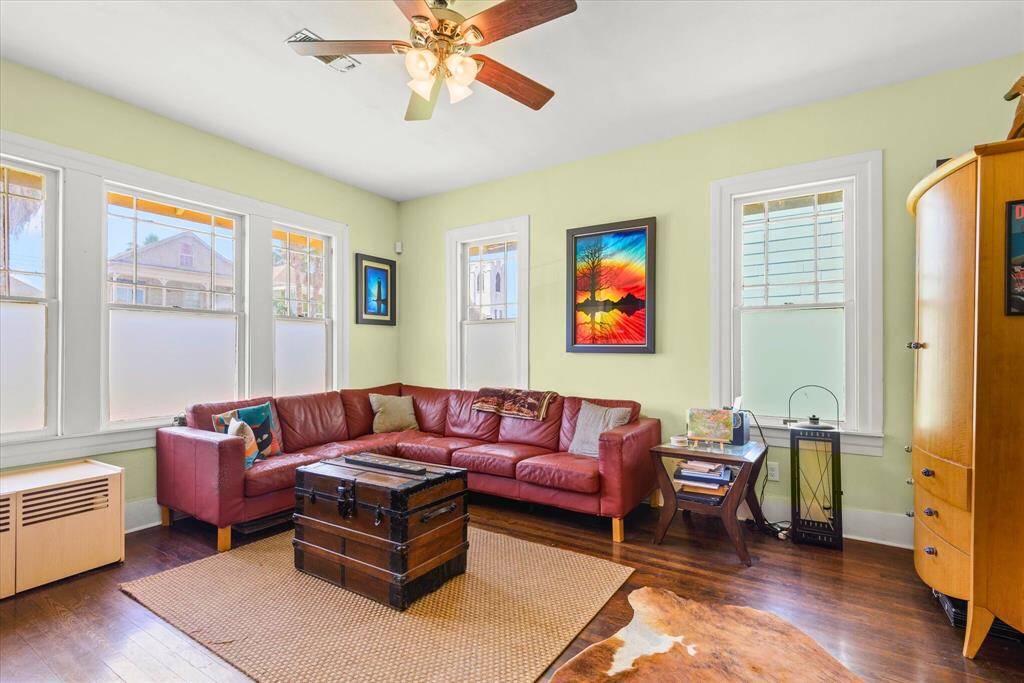 Bright and inviting Living Room with multiple windows creating a welcoming space