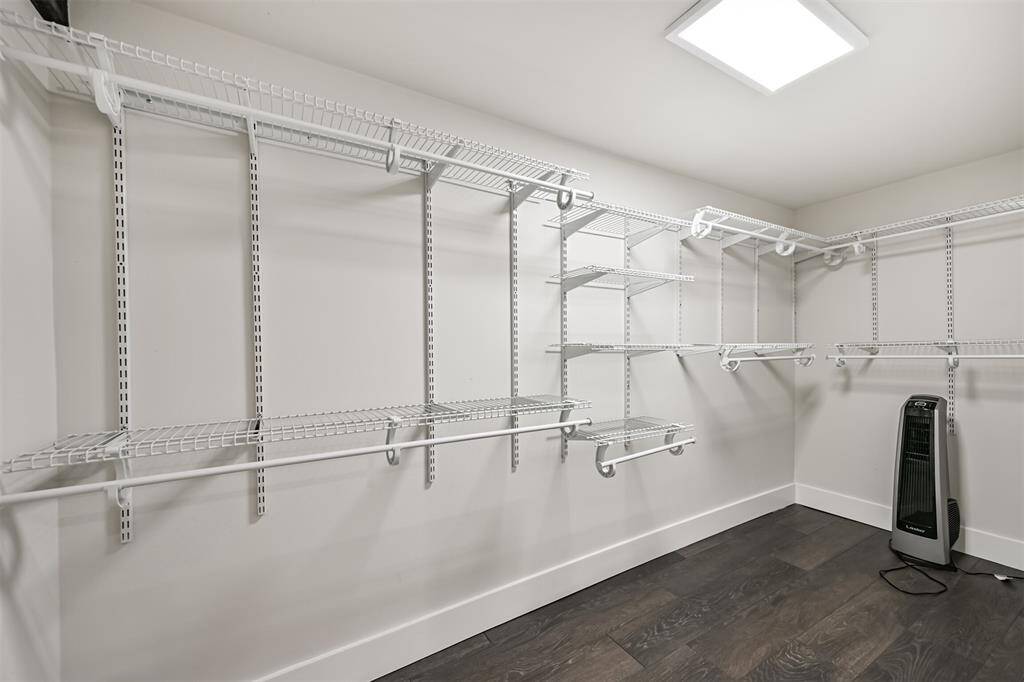 Large walk-in closet in downstairs primary bedroom.