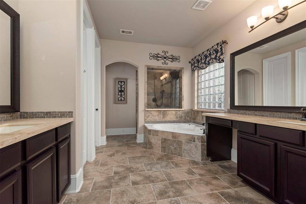 Luxurious primary bedroom ensuite with double sinks, great counter space/storage, vanity area, soaking tub, separate shower and 2 walk in closets.
