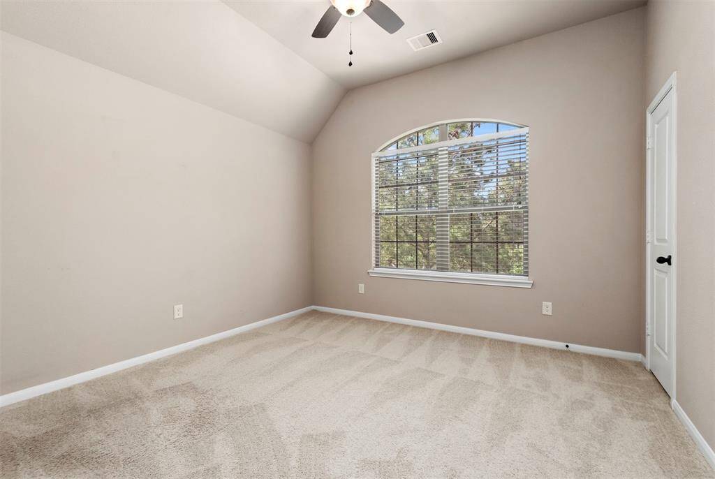 Bedroom #2 up with tall ceiling and walk in closet.