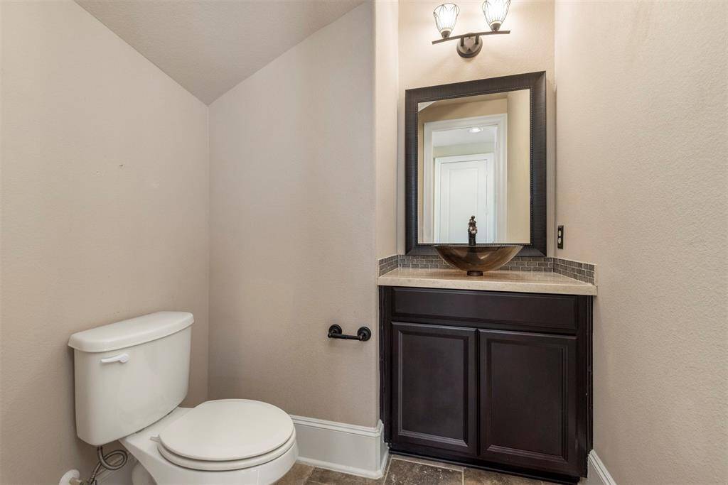 Guest bath down is spacious with a pretty vessel sink.