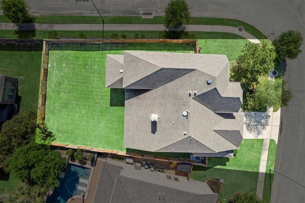 Aerial view showing corner lot and large yard.