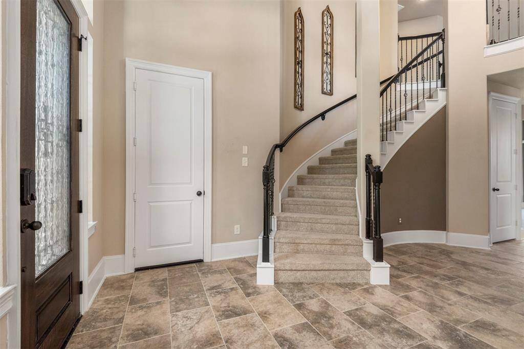 Another view of the grand entrance with sweeping staircase. The circular nook is the perfect spot for the Christmas tree.