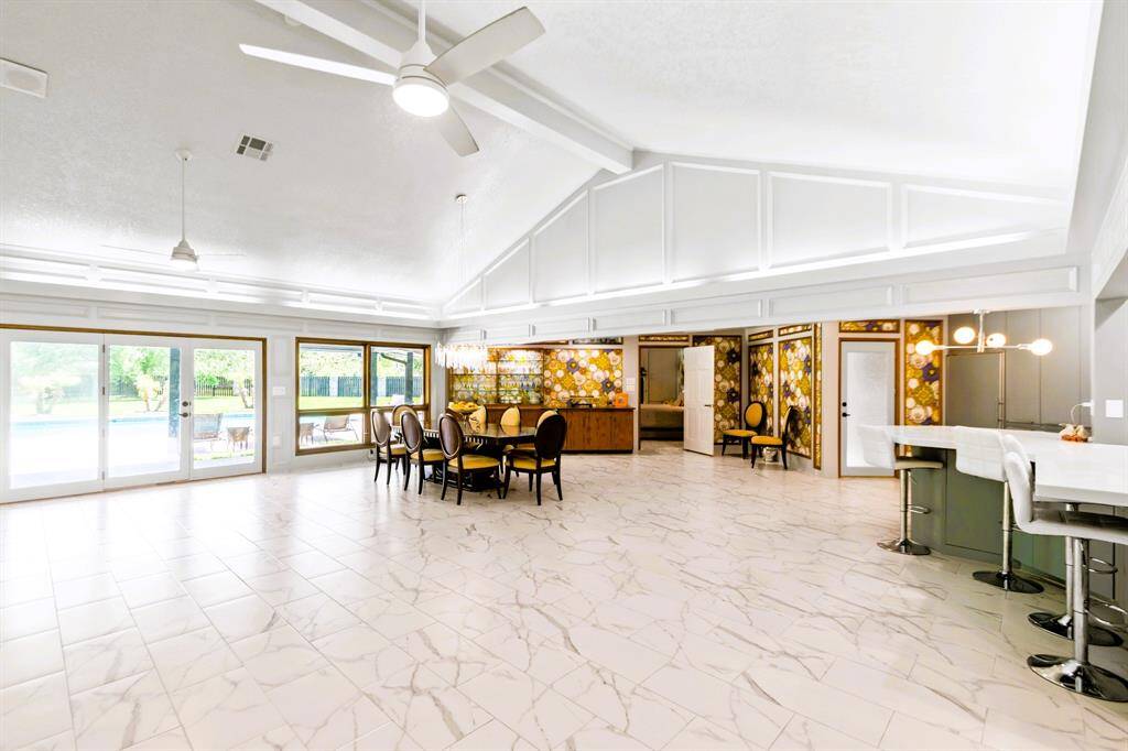 The living room, dining room, and kitchen flow seamlessly in an open-concept design, perfect for modern living and entertaining.
