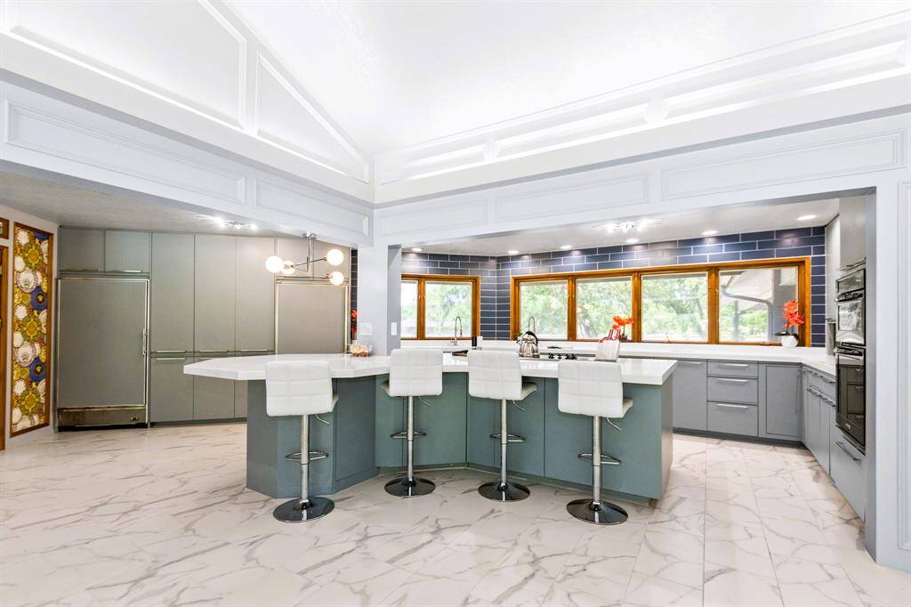 The spacious kitchen features a Sub-Zero fridge and freezer, combining luxury with exceptional functionality.