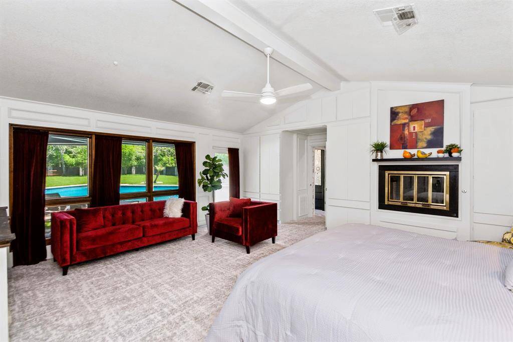 The massive primary bedroom, located on its own side of the house, offers stunning views of the backyard for ultimate privacy and tranquility.