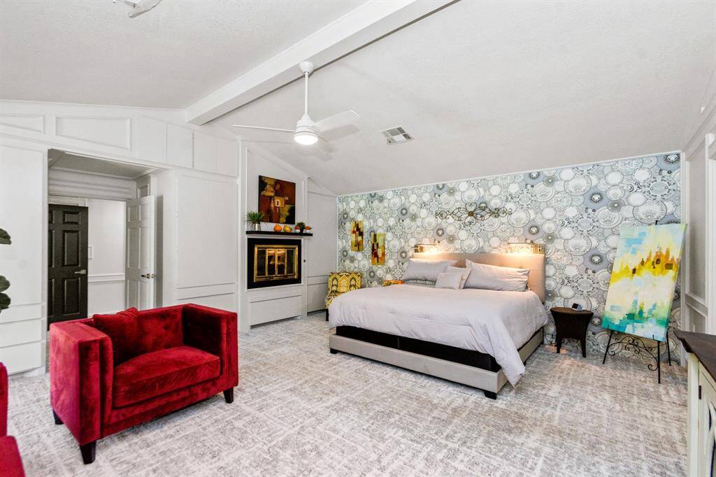 The massive primary bedroom, located on its own side of the house, offers stunning views of the backyard for ultimate privacy and tranquility.