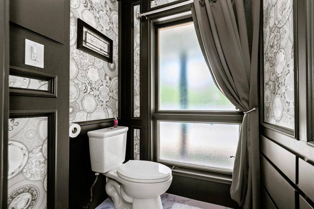 The primary bath is a secluded sanctuary, exuding sleek, chic elegance for a truly luxurious experience.