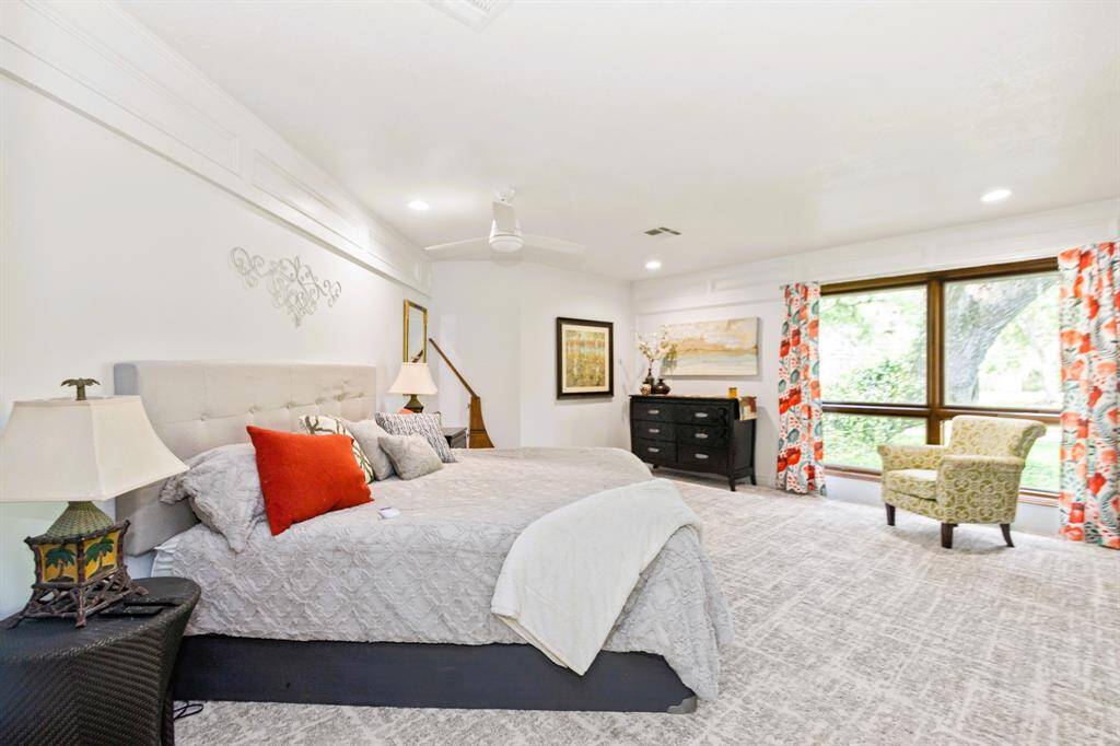 The spacious third bedroom is enhanced with built-in bookshelves and luxurious designer carpeting, creating a stylish and functional retreat.