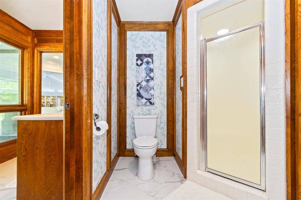 The bathroom, shared by the bedrooms on one side of the home, is spacious and well-appointed, offering both convenience and comfort.