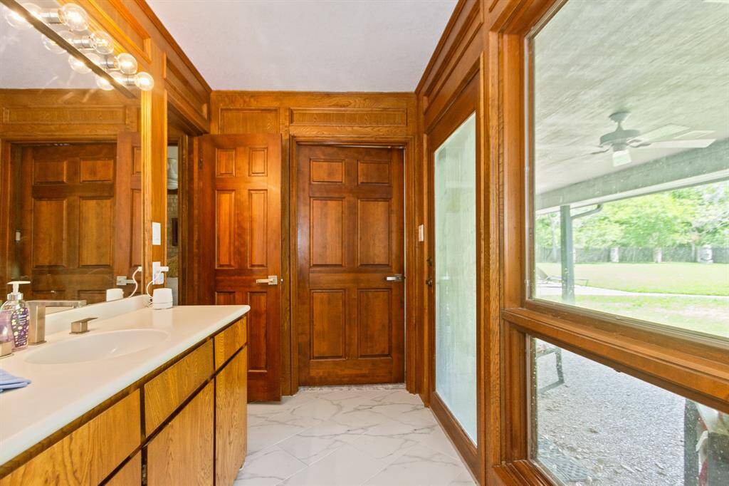 The bathroom, shared by the bedrooms on one side of the home, is spacious and well-appointed, offering both convenience and comfort.