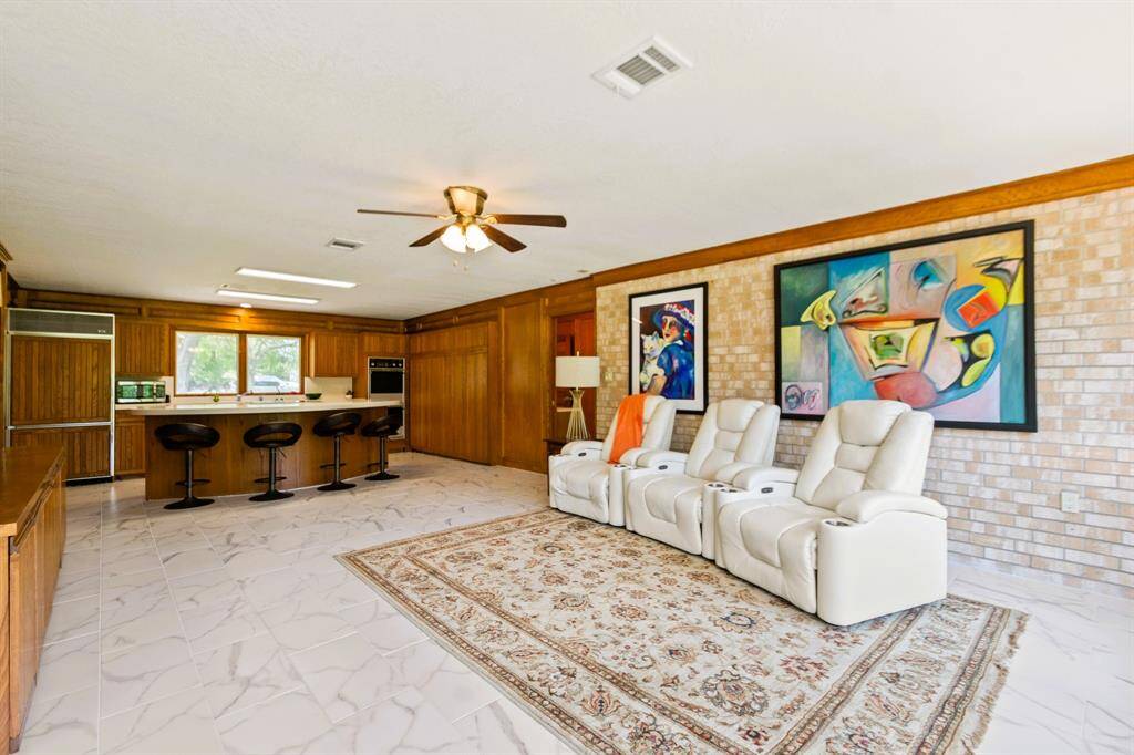 The guest house features its own cozy living room, seamlessly flowing into the open-concept kitchen for a spacious, airy feel.
