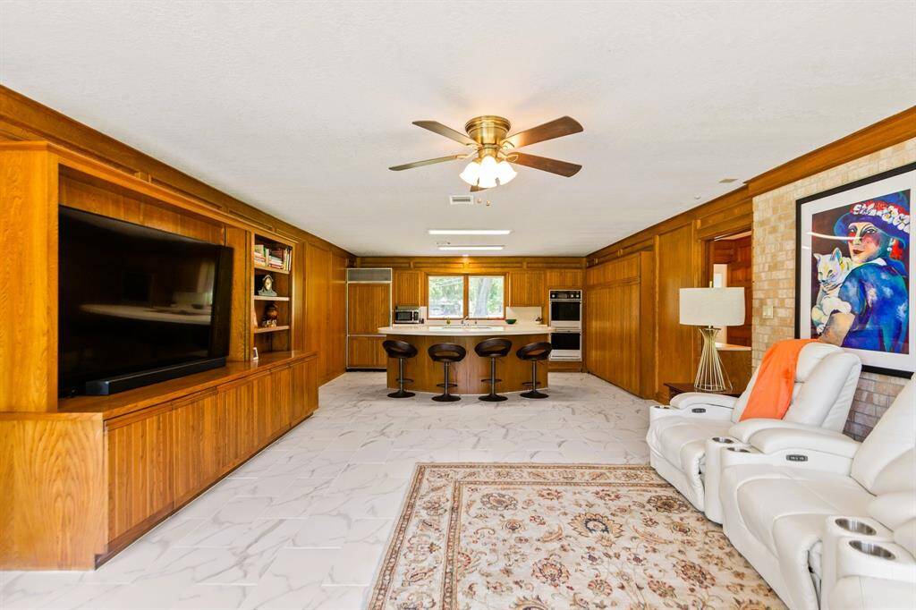 The guest house features its own cozy living room, seamlessly flowing into the open-concept kitchen for a spacious, airy feel.