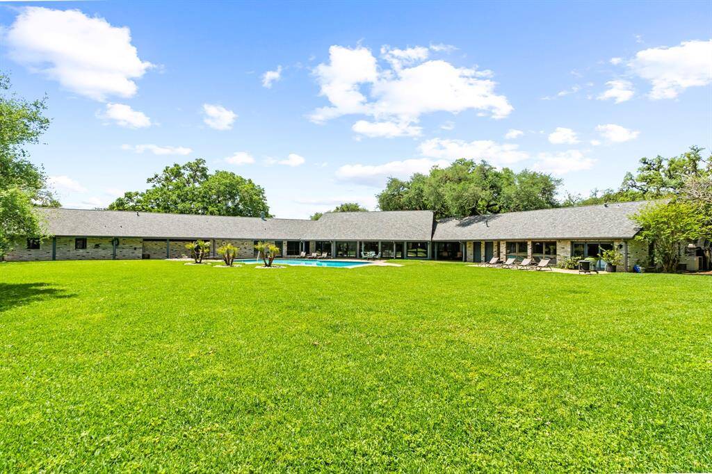 The 2-acre yard is fully fenced, offering a vast, private space perfect for outdoor activities, gardening, or simply enjoying the tranquility of nature.