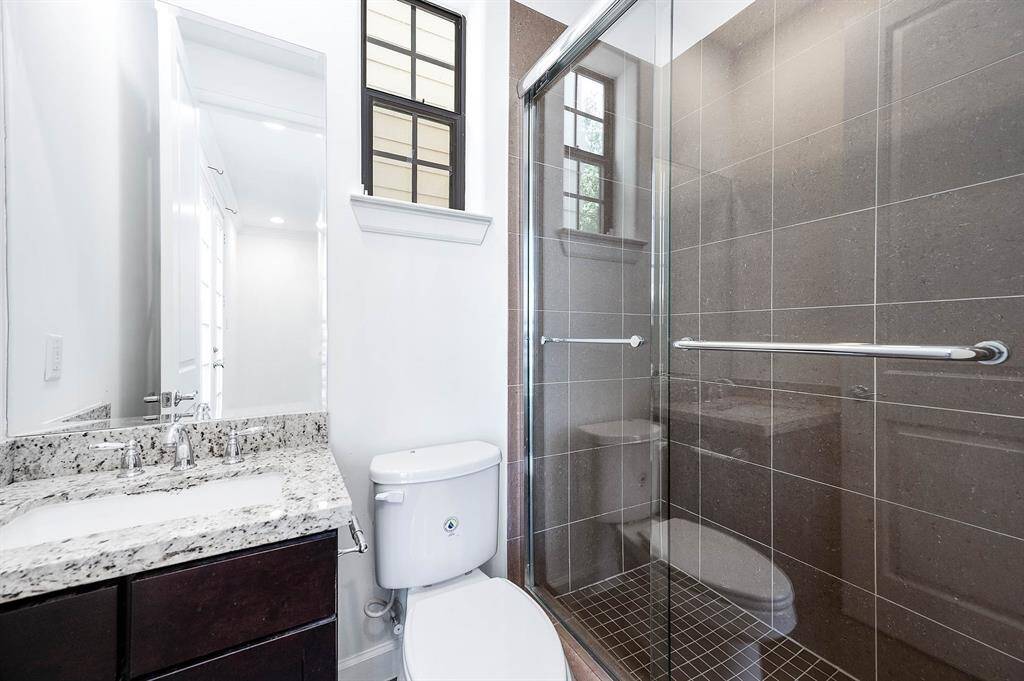 Bathroom One With Granite Countertops And Luxurious Shower.