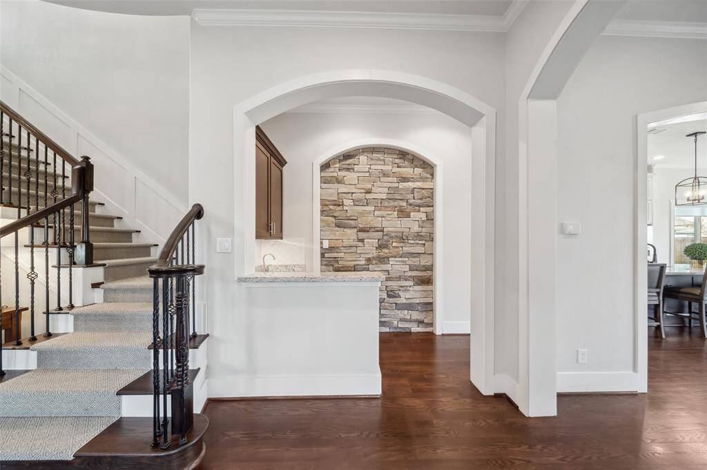 The butler’s pantry is a standout feature, boasting a rock inlay, built-in wine fridge, and sleek granite countertops—perfect for entertaining and additional storage.
