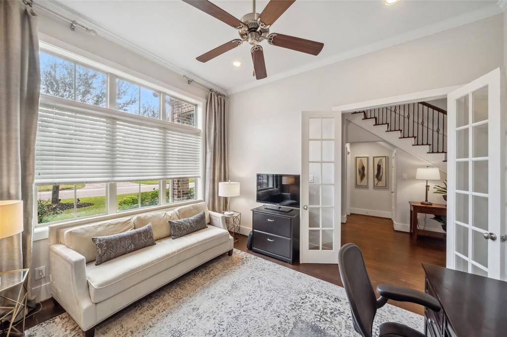 The dedicated office is perfectly positioned at the front of the home, featuring massive windows that flood the space with natural light and beautiful French doors for added elegance and privacy.