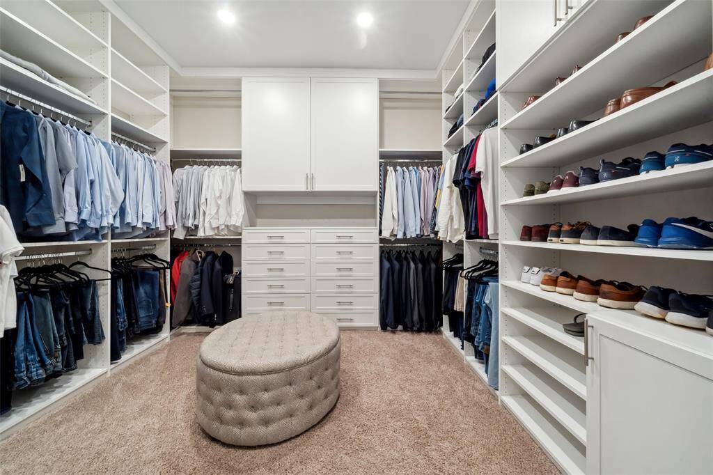 The primary closet is a dream, featuring loads of built-ins for optimal organization, offering ample space for clothing, shoes, and accessories.