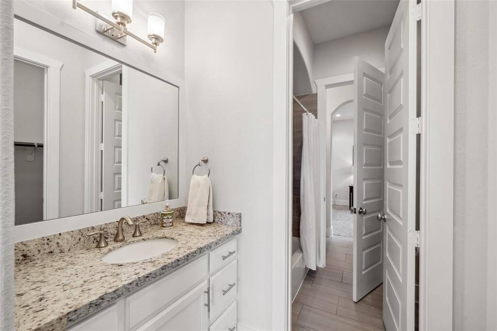 Featuring private vanities and a shared tub/shower combo, this Hollywood bath provides the perfect balance of privacy and convenience!