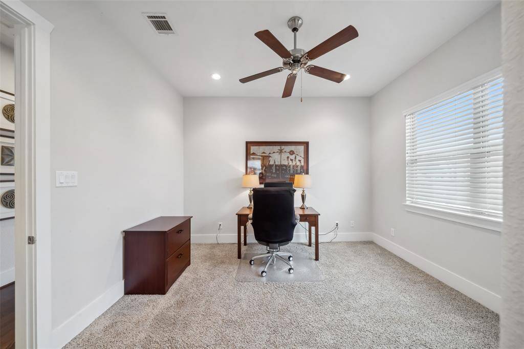 The third secondary bedroom is currently staged as an office, offering versatility to suit your needs—whether as a workspace, guest room, or bedroom.