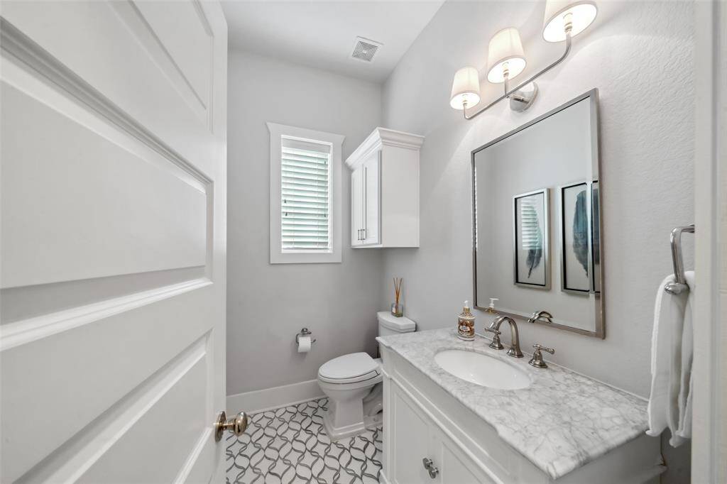 A glimpse of the beautiful half bath on the first floor, featuring elegant design details, stylish fixtures, and a thoughtfully curated aesthetic.