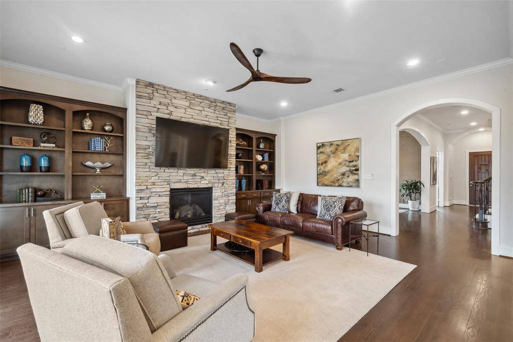 Through the arched opening on the right, you'll find the dining room elegantly positioned to the left, offering a seamless flow for entertaining and everyday gatherings.