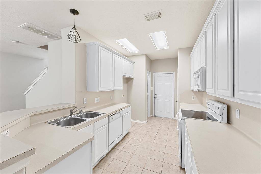 Roomey galley kitchen with ample cabinets & counter space. Electric range/oven with gas option if you want gass cooking.
