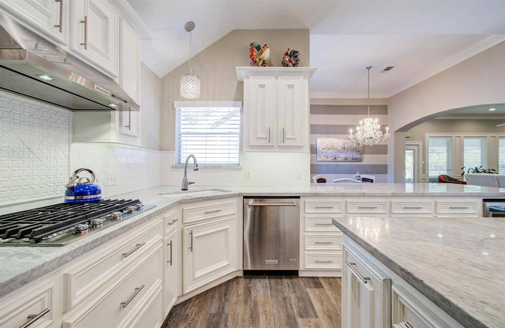 Sleek granite counter tops, gas cooktop and ample prep space and storage!