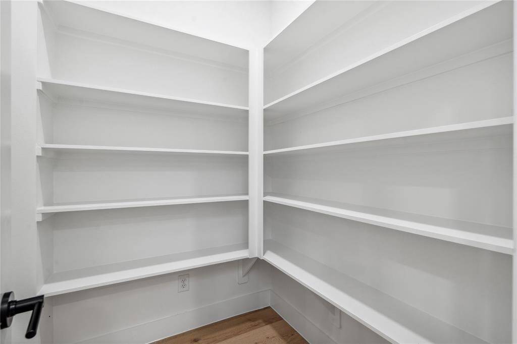 An oversized walk in pantry also comes with custom shelves.